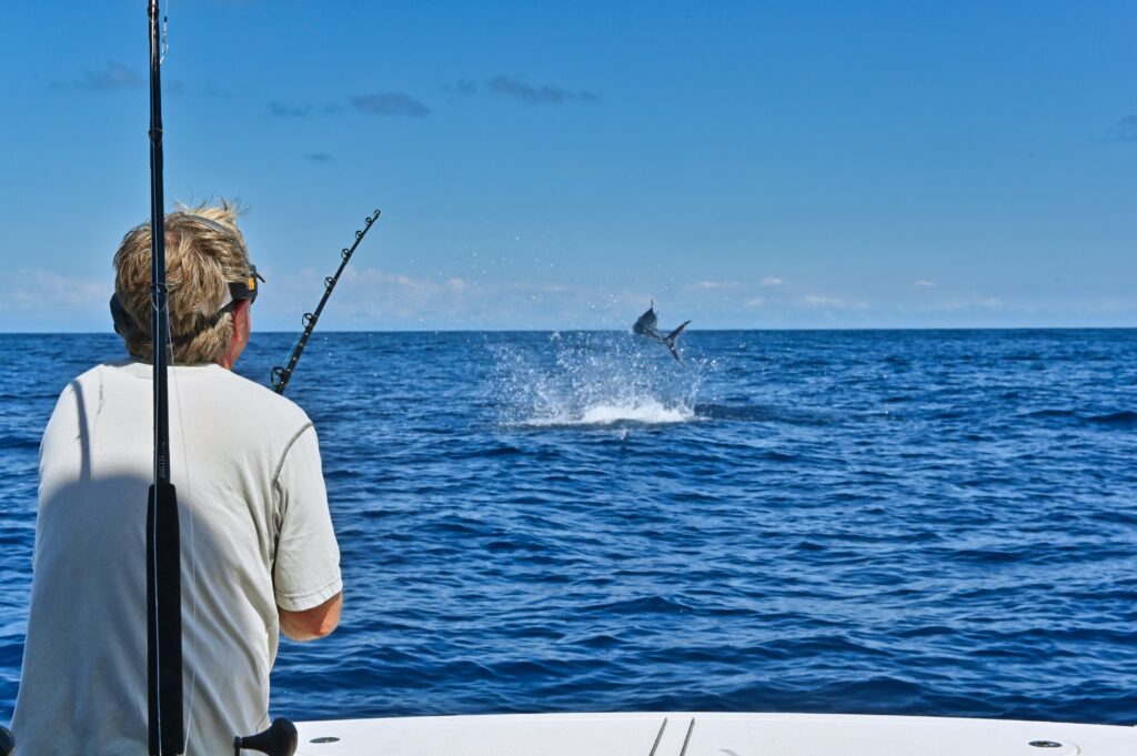 Pat Healey, President and CEO of Viking Yachts, watching a billfish jump off Los Sueños, Costa Rica